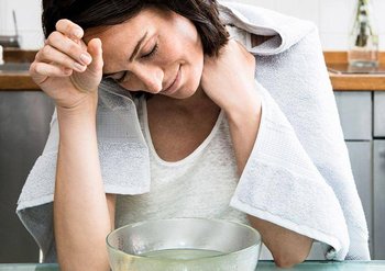 Frau über einem Gesichtsdampfbad