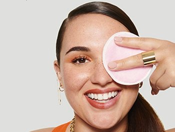 Frau entfernt Augen-Make-up mit einem Wattepad und Garnier Mizellenwasser