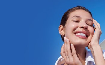 Lächelnde Frau sonnt ihr Gesicht