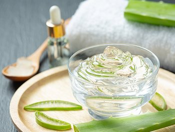 Stillleben mit Garnier Produkt im Hintergrund und einem Glas Wasser