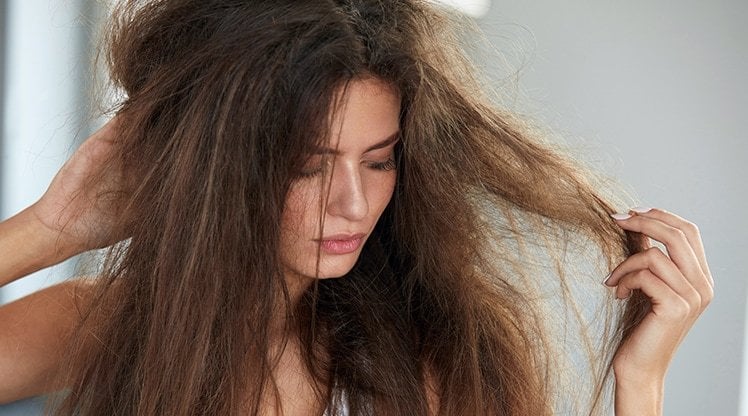 Frau mit langen, sehr widerspenstigen Haaren 