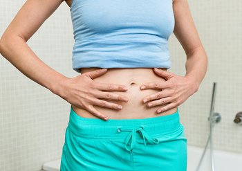 Frau berührt ihren Bauch