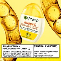 Garnier Wonder Tint All-In-One Getöntes Fluid mit 5% Glycerin, Niacinamid und Vitamin C, für Glow Boost und Milderung von dunklen Flecken in Einem. Hier vor einem wisschenschaftlichen Garnier Hintergrund abgebildet.
