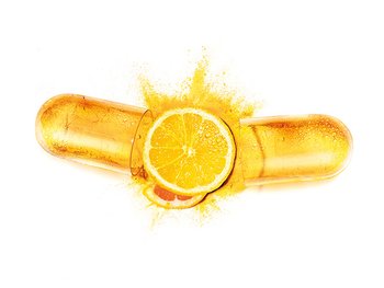 Abstrakte Darstellung einer Zitrone zwischen einer Vitaminkapsel.