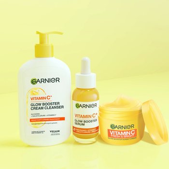 Drei Produkte der Garnier Vitamin C Reihe stehen nebeneinander: Der Vitamin C Cream Cleanser, das Vitamin C Glow Booster Serum und die Vitamin C Sorbet Creme.